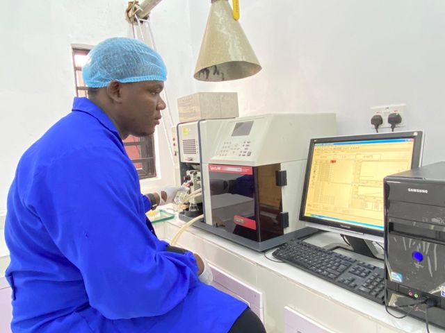 JEL laboratory technician operating spectrometer analytical equipment